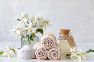 spa concept of jasmine oil, with bath salt and flowers