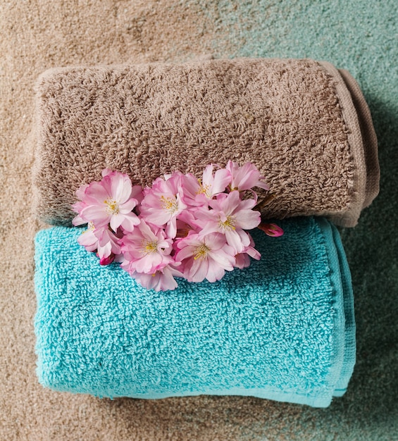 Spa Concept. Top view of beautiful Spa Products. Beautiful flowers, towels, spa salt, sand.