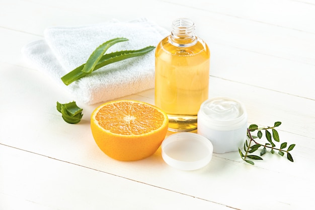 Spa concept with salt, mint, lotion, towel on white background
