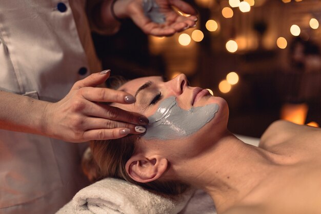 Spa concept with woman with creme in face