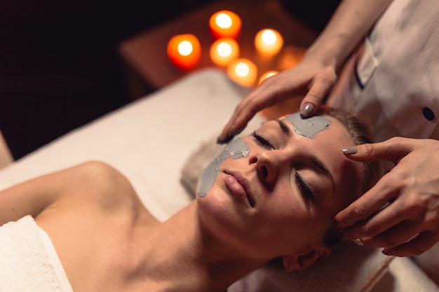 Spa concept with woman with creme in face