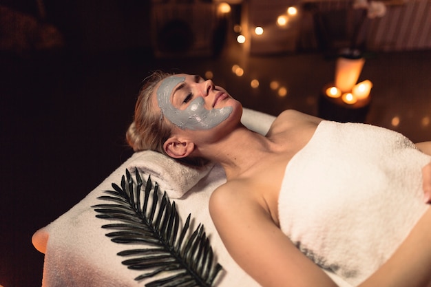 Spa concept with woman with creme in face