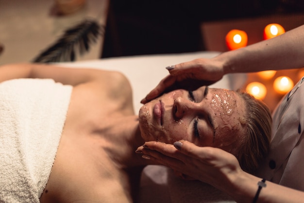 Spa concept with woman with creme in face
