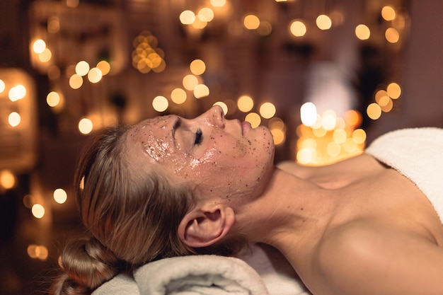 Spa concept with woman with creme in face