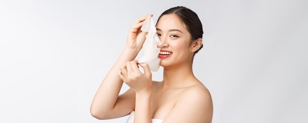 Spa healthcare Woman with purifying mask on her face isolated on white background