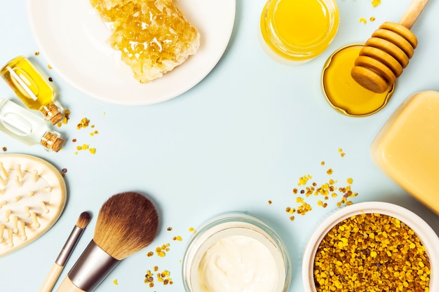 Spa ingredient and equipment arrange in circular frame on blue background