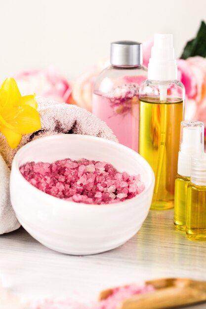 Spa setting with pink roses and aroma oil, vintage style