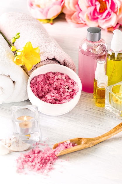 Spa setting with pink roses and aroma oil, vintage style