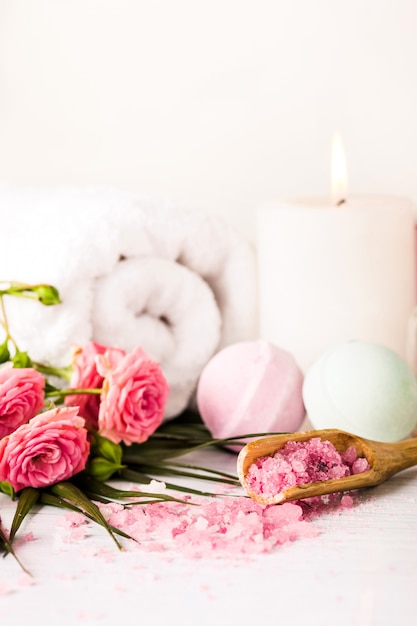 Free photo spa setting with pink roses and aroma oil, vintage style