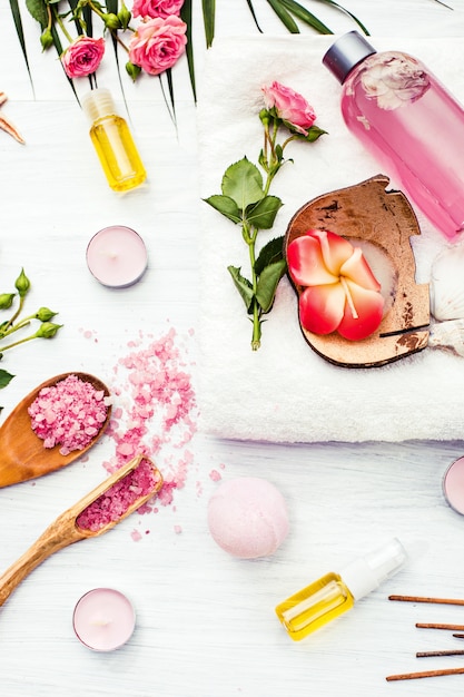 Free photo spa setting with pink roses and aroma oil, vintage style