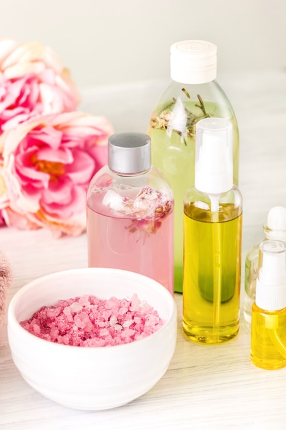 Spa setting with pink roses and aroma oil, vintage style