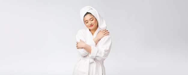 Spa skincare beauty Asian woman drying hair with towel on head after shower treatment Beautiful multiracial young girl touching soft skin