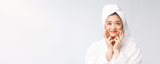 Spa skincare beauty Asian woman drying hair with towel on head after shower treatment Beautiful multiracial young girl touching soft skin