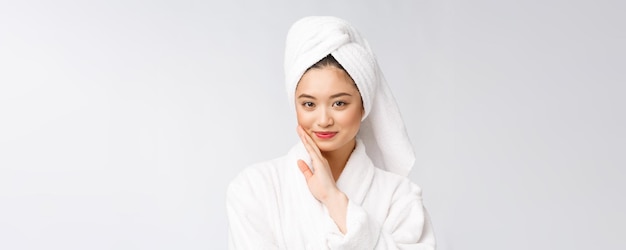 Spa skincare beauty Asian woman drying hair with towel on head after shower treatment Beautiful multiracial young girl touching soft skin