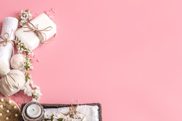 Spa still life on pink background with spring flowers