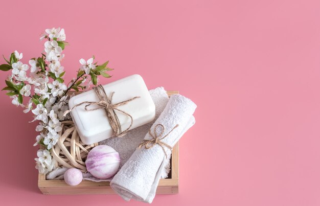 Spa still life on pink wall with spring flowers