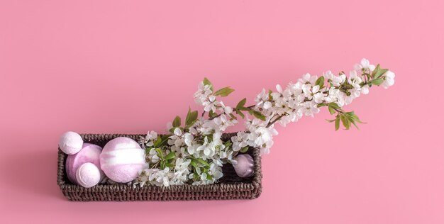 Spa still life on pink wall with spring flowers