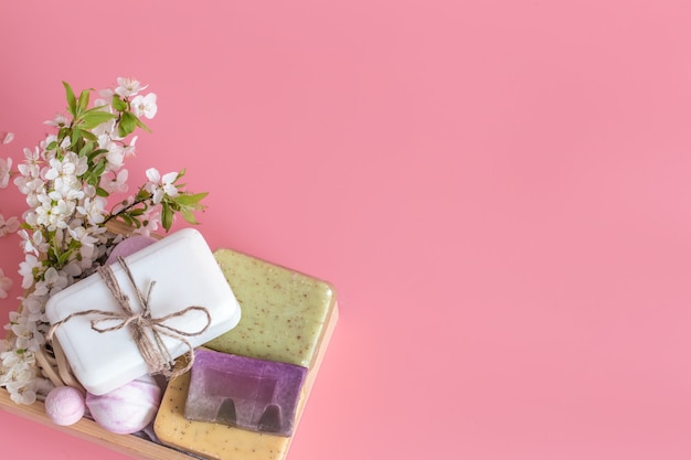 Spa still life on pink wall with spring flowers