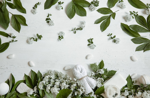 Spa still life with bath accessories, health and beauty products with fresh flowers.