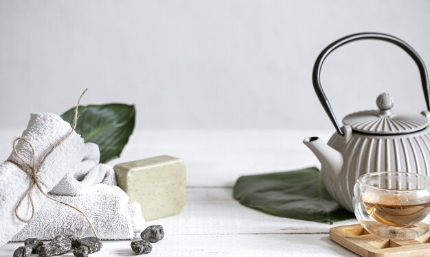 Spa still life with face and body skin care products and tea.