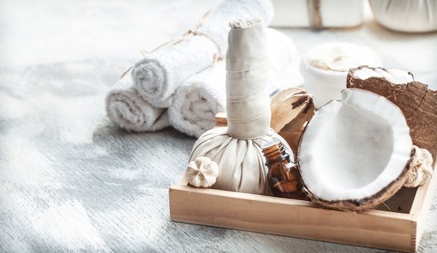 Spa still life with fresh coconut and body care products