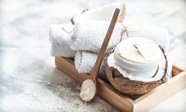 Spa still life with fresh coconut and body care products