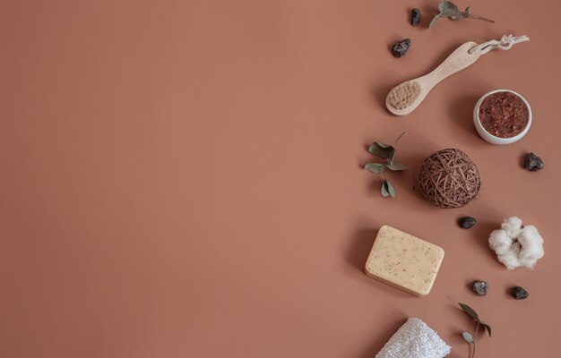 Spa still life with natural toothbrushes, scrub, soap and decorative details flat lay.