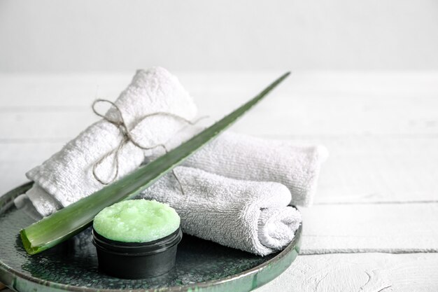 Spa still life with organic skincare, fresh aloe leaf and towels. The concept of beauty and organic cosmetics  background