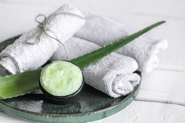 Spa still life with organic skincare, fresh aloe leaf and towels. The concept of beauty and organic cosmetics.