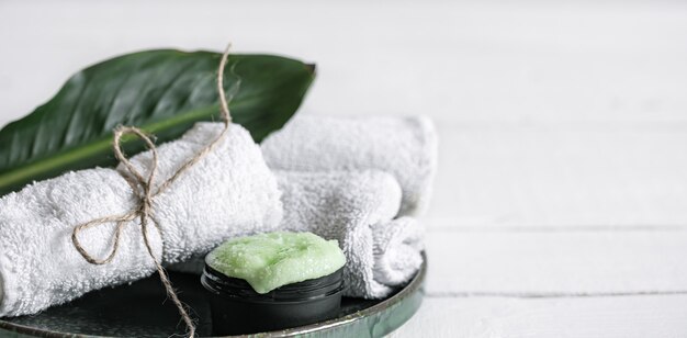 Spa still life with organic skincare, natural leaf and towels copy space. The concept of beauty and organic cosmetics.