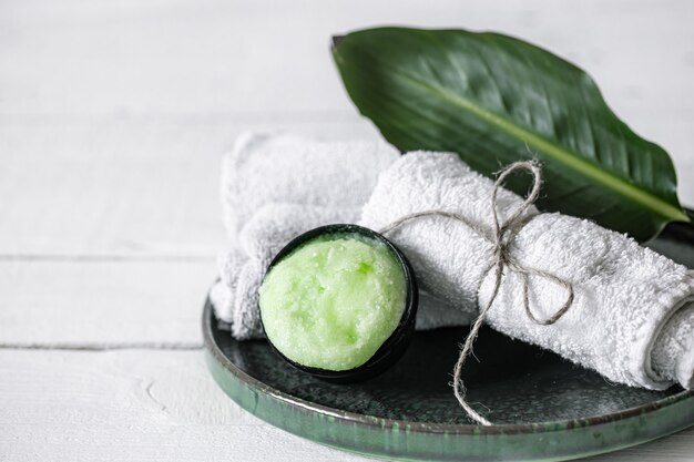 Spa still life with organic skincare, natural leaf and towels copy space. 