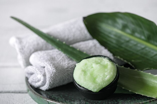 Spa still life with organic skincare, natural leaves and towels. The concept of beauty and organic cosmetics.