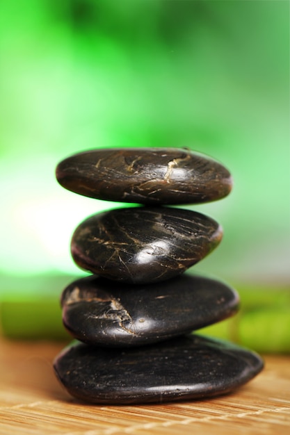 Free photo spa and wellness, massage stones and flowers on wooden tablecloth