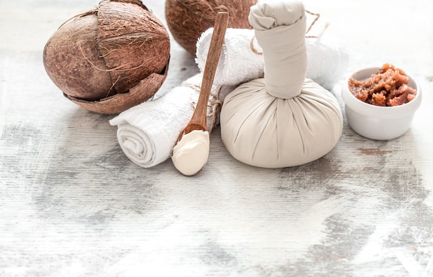 Spa and wellness setting with flowers and towels. Bright composition with lavender flowers. Dayspa nature products with coconut