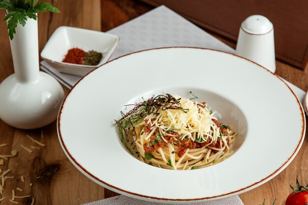 Spaghetti bolognese  parmesan on top  side view