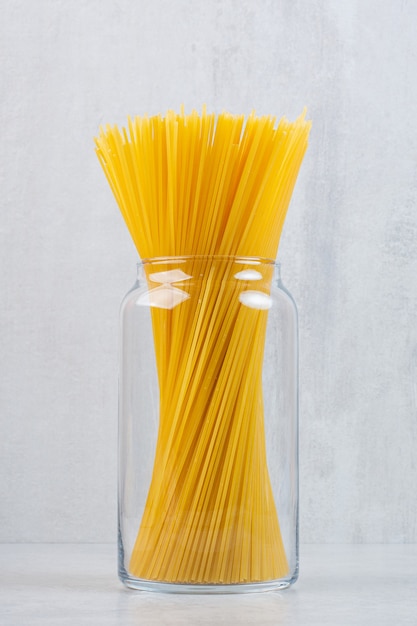 Spaghetti pasta in a jar, on the marble.