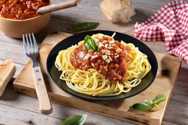 Spaghetti with bolognese sauce on wooden tablexA
