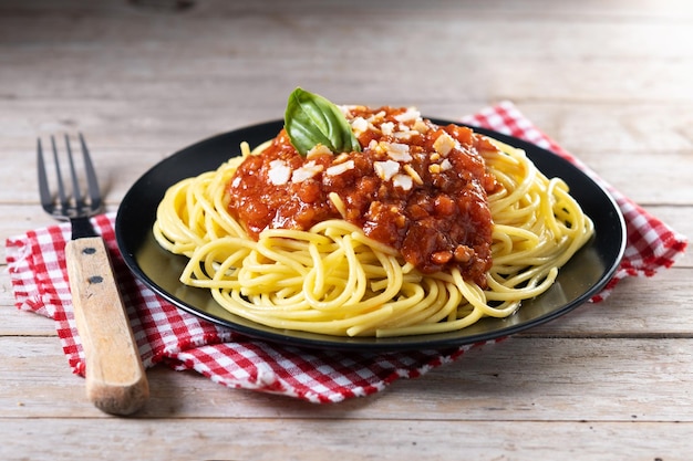 Spaghetti with bolognese sauce on wooden tablexA