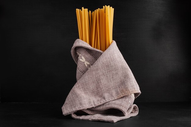 Spaghetties wrapped with a kitchen towel. 