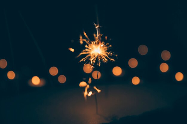 Sparkler on blurred bokeh background