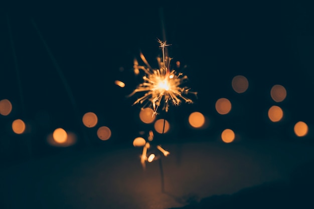 Sparkler on blurred bokeh background