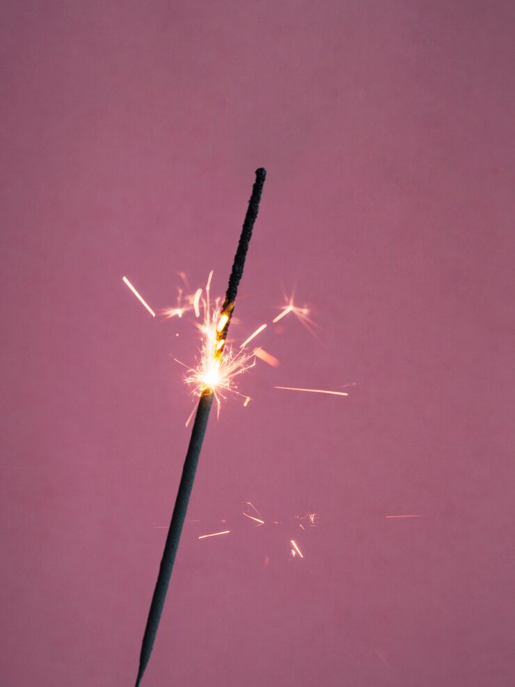 Free Photo sparkler burning on pink