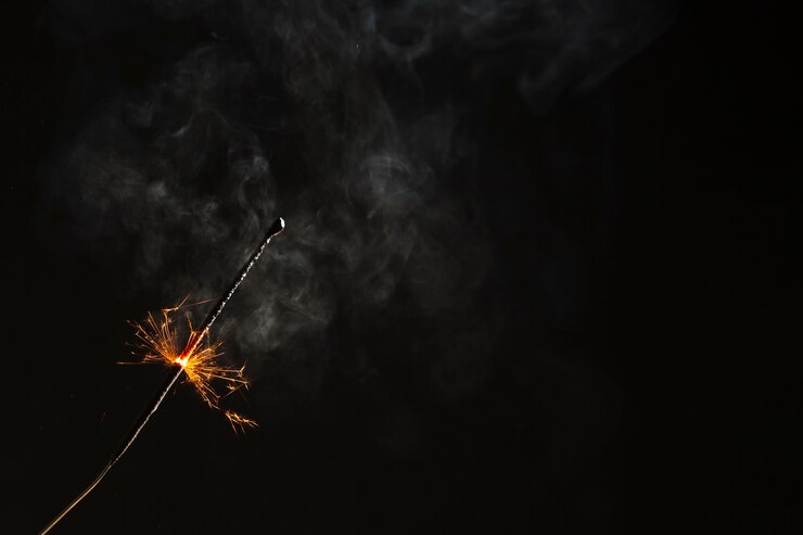 Free Photo sparkler flaming on black background
