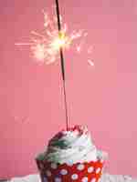 Free photo sparkler put into the cupcake