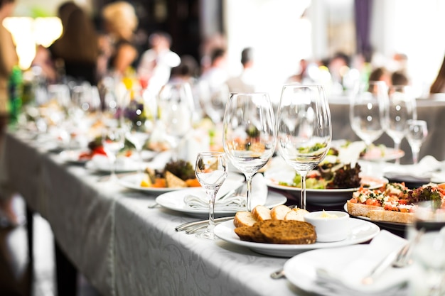 Free photo sparkling glassware stands on long table prepared for wedding di