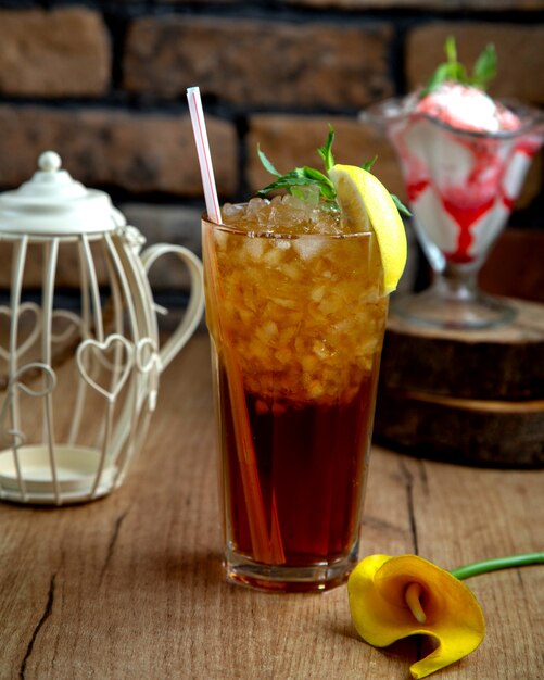 Sparkly drink with ice garnished with lemon and mint