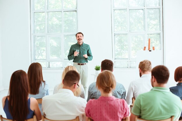 Speaker at Business Meeting in conference hall.