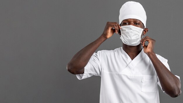 Specialist male doctor arranging the mask