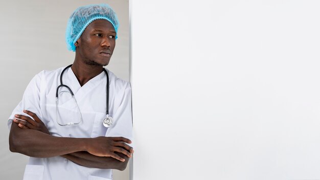 Specialist male doctor leaning on a wall