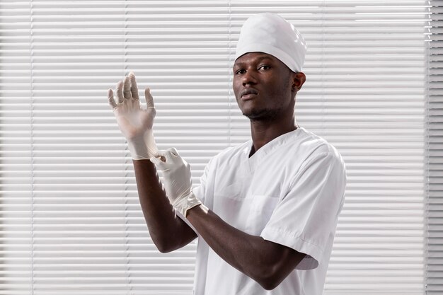 specialist male doctor putting his gloves